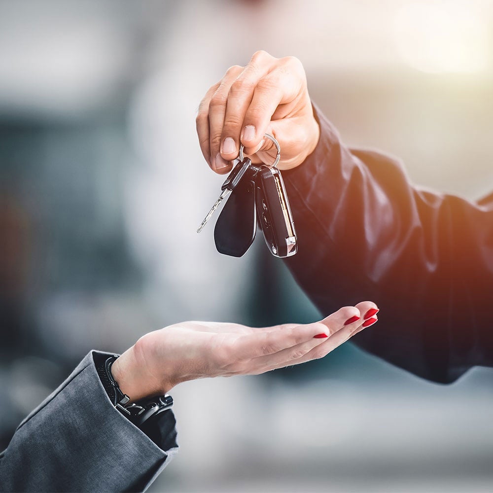 Man and woman standing next to car